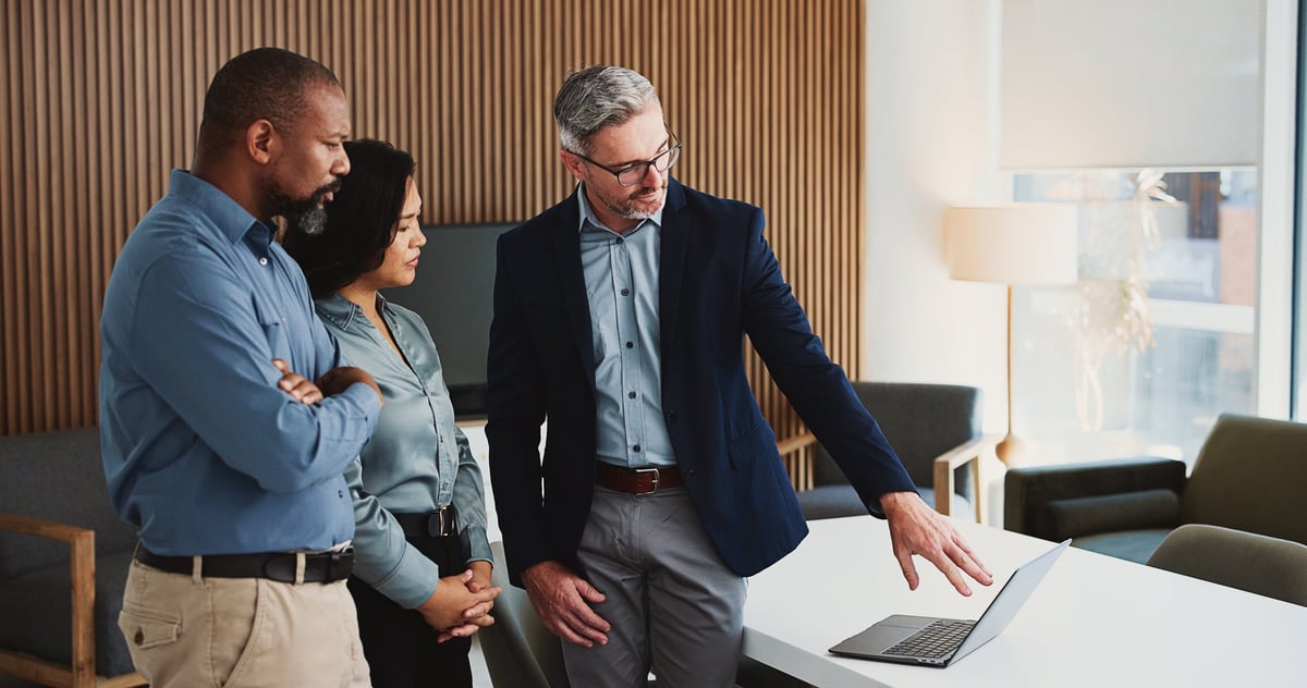 A team reviewing financial documents and business plans in a modern office